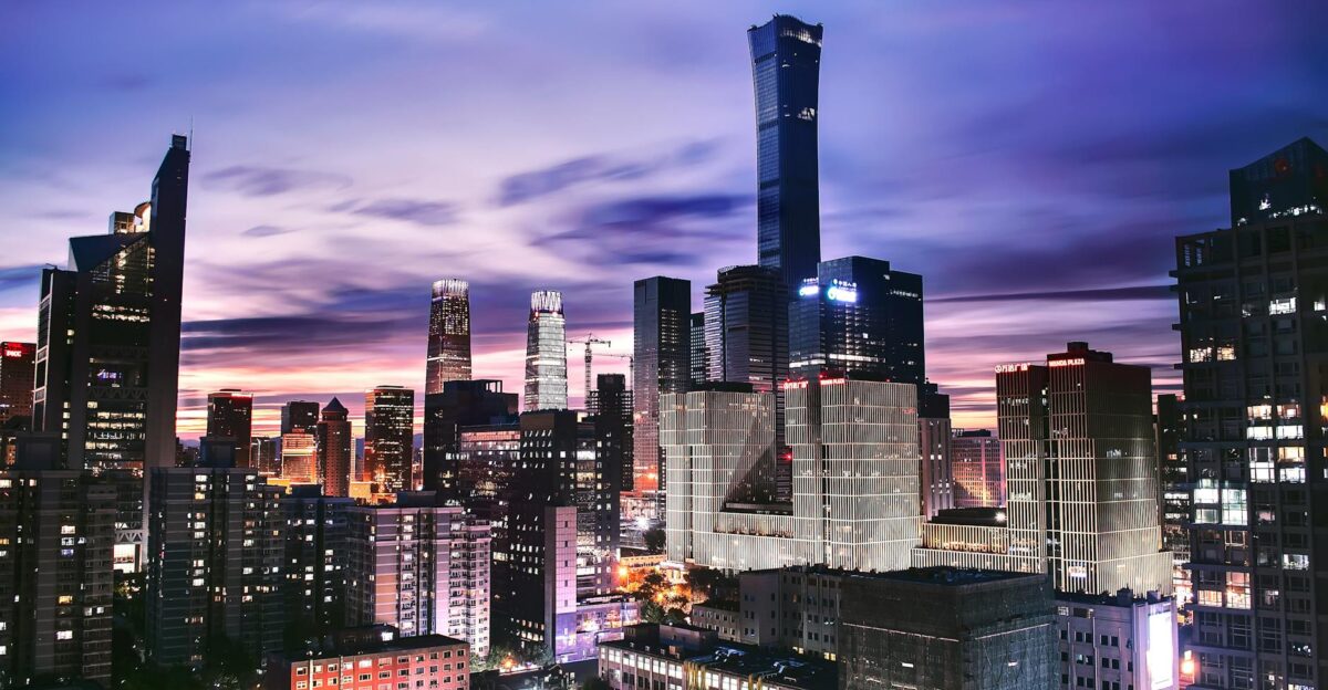 Explore the vibrant skyline of Beijing as twilight paints the horizon in this stunning aerial shot