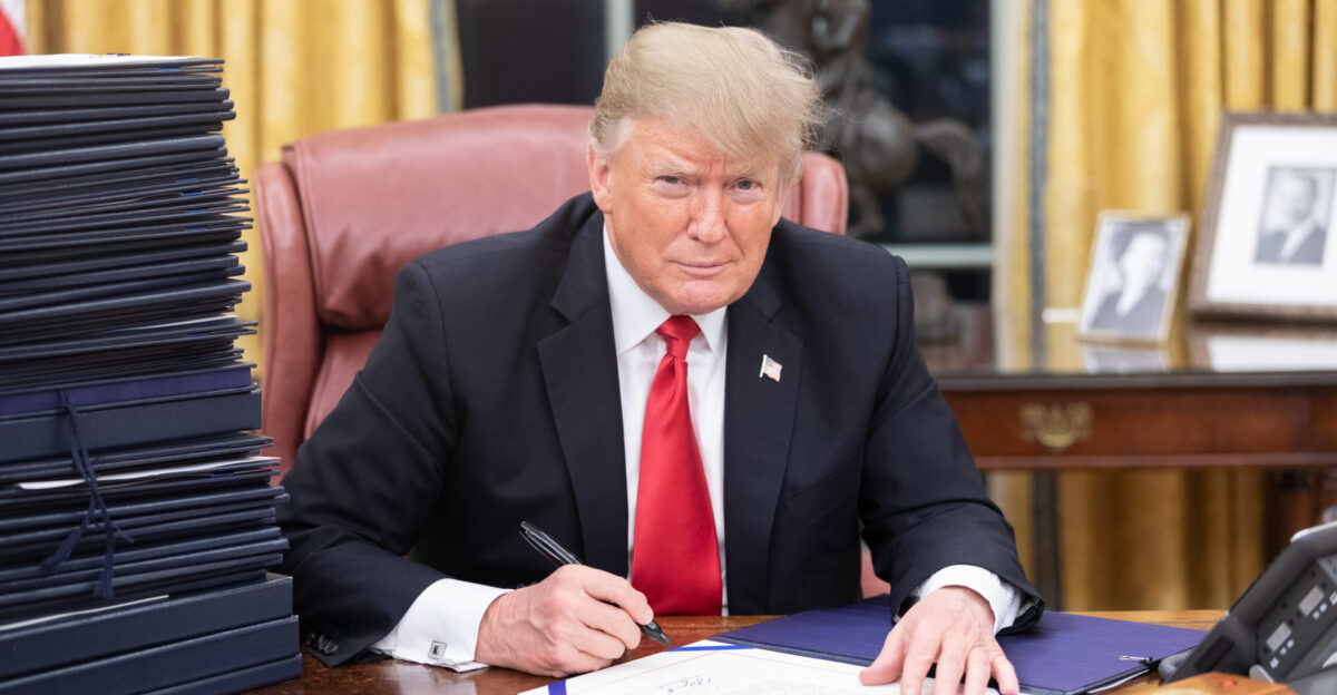 President Donald J Trump is seen at his desk Friday evening December 21 2018 in the Oval Office with a stack of documents awaiting his signature Official White House Photo by Shealah Craighead